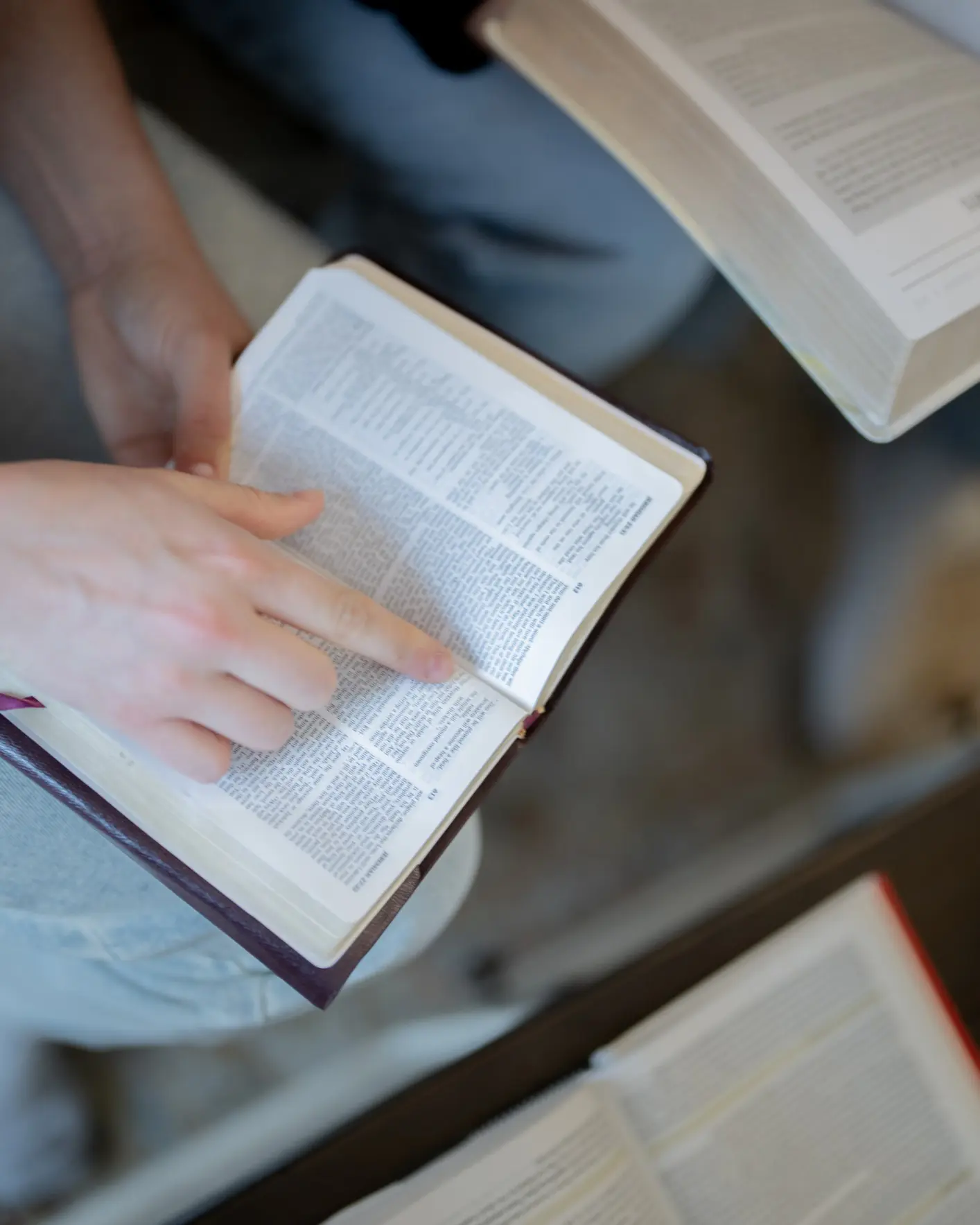 Open book with finger on page