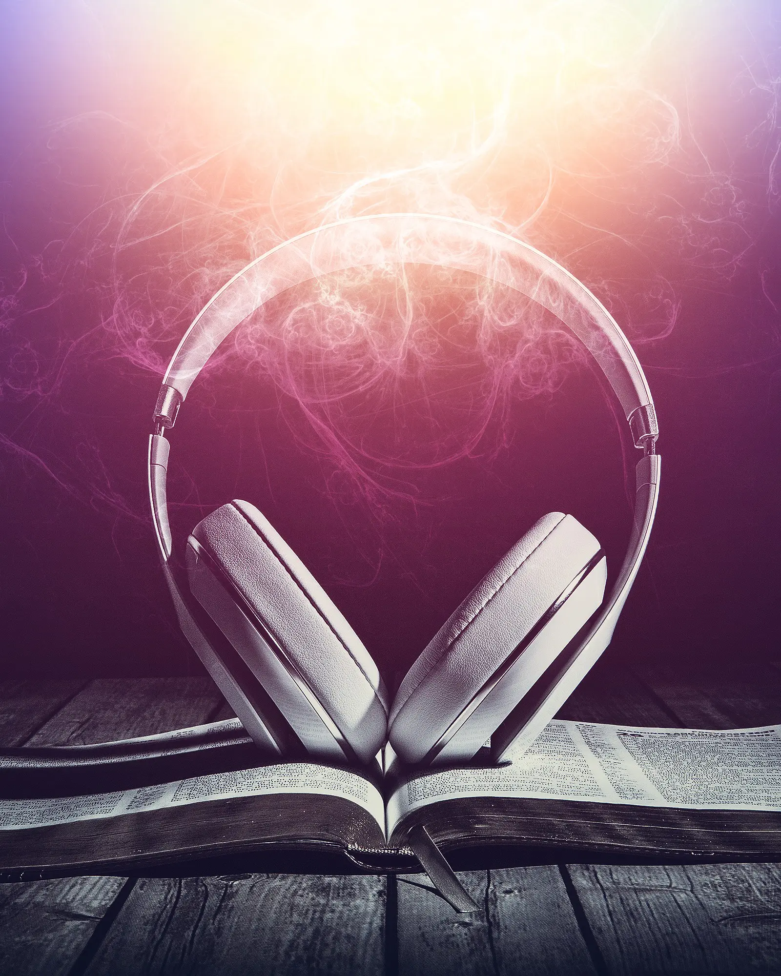 Headphones on open book with light