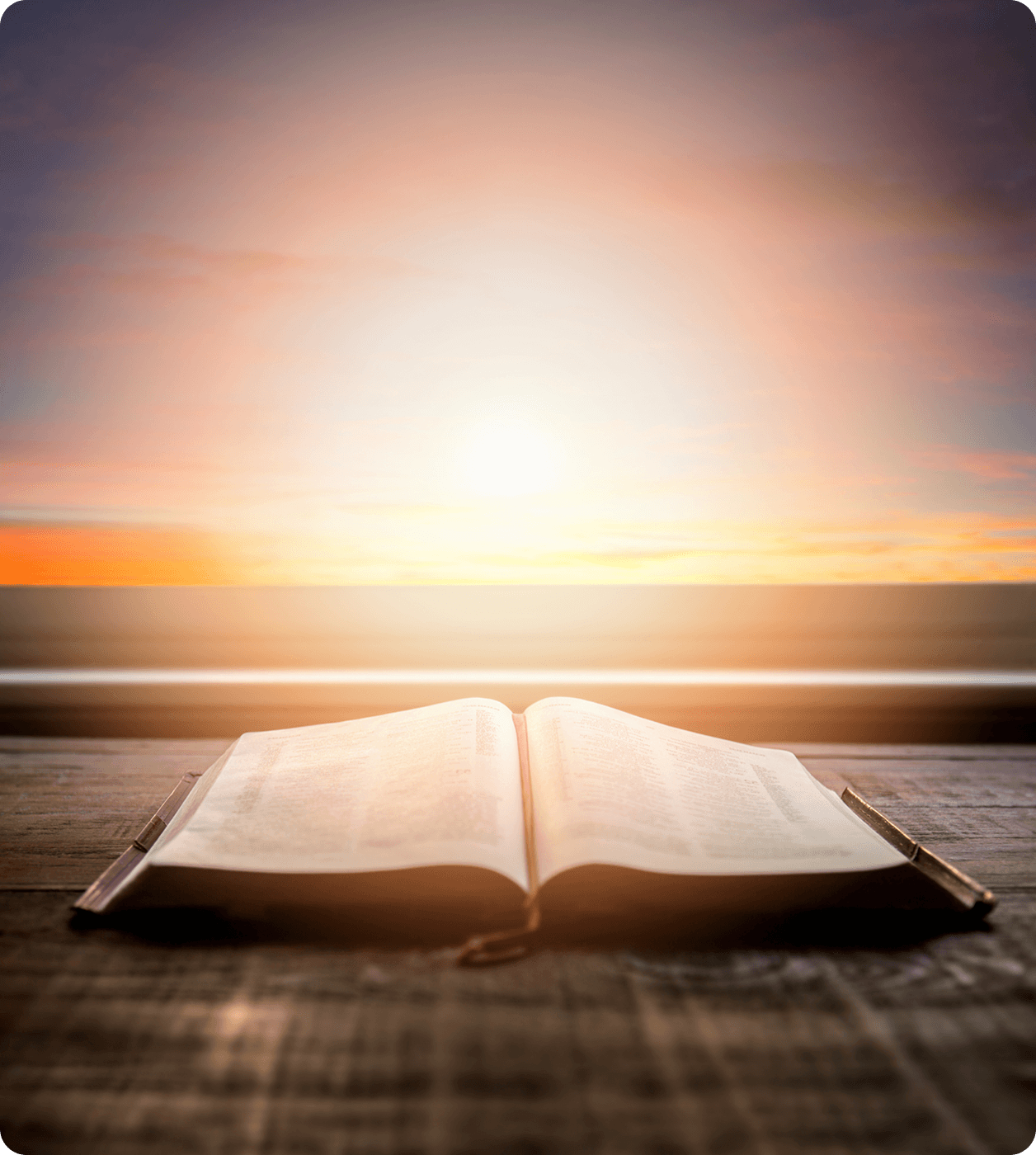 Open book with a sunrise background